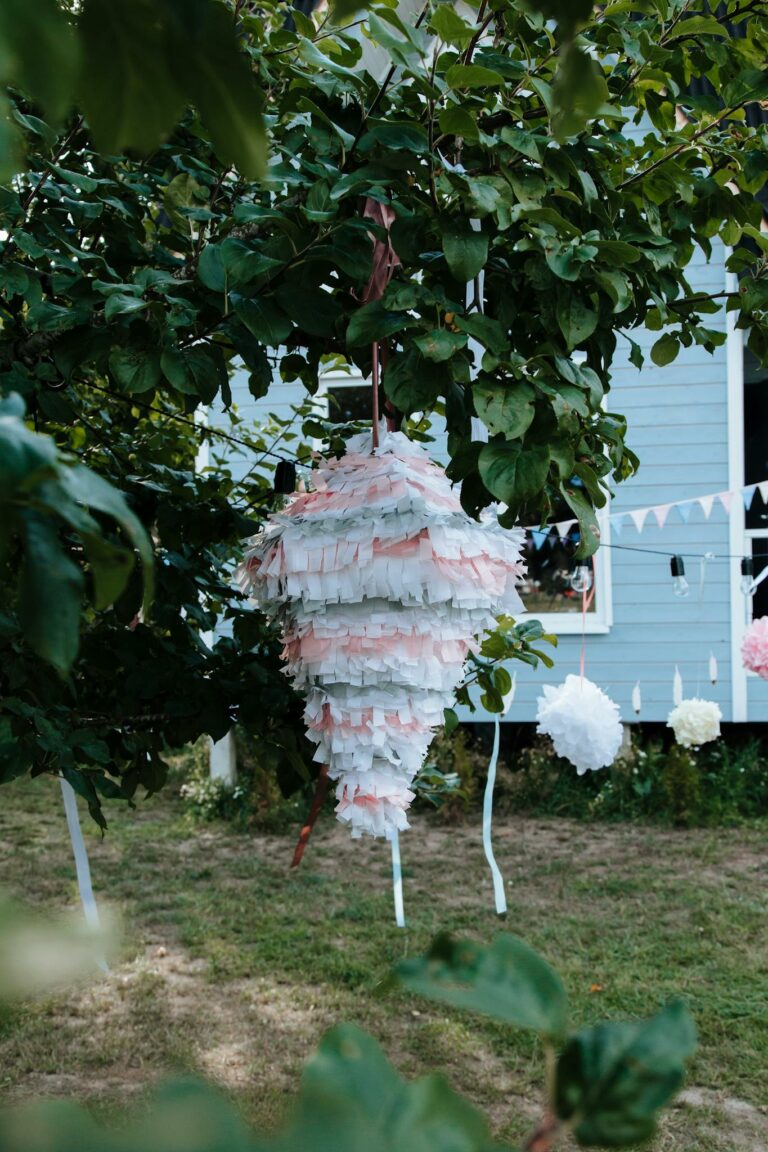 Festive outdoor setting featuring a colorful pinata hanging from a tree.